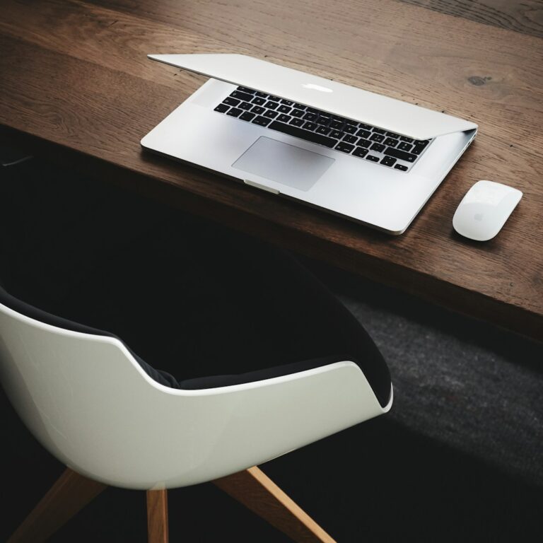 Apple MacBook beside computer mouse on table